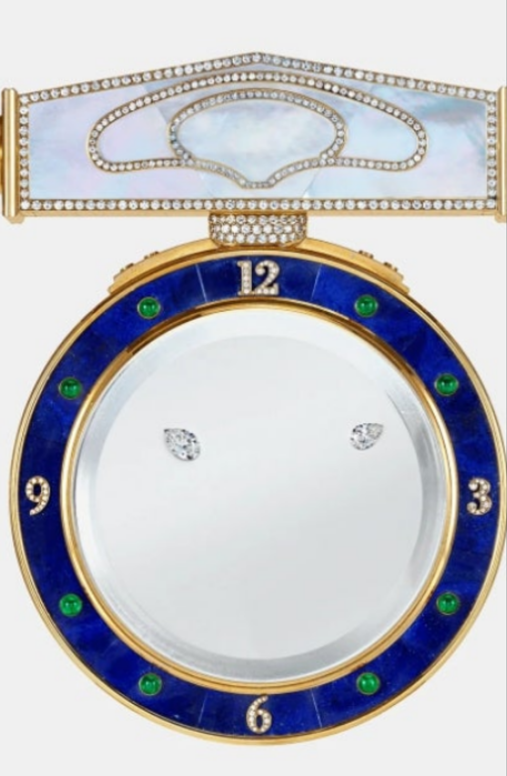 Diamond Mystery Clock Floating 2,150 grams of 18K yellow gold and it is adorned with an array of exceptional gemstones: two pear-shaped diamonds (3.02 and 1.79 carats), 49.96 carats of round-cut diamonds and 9.60 carats of cabochon emeralds.