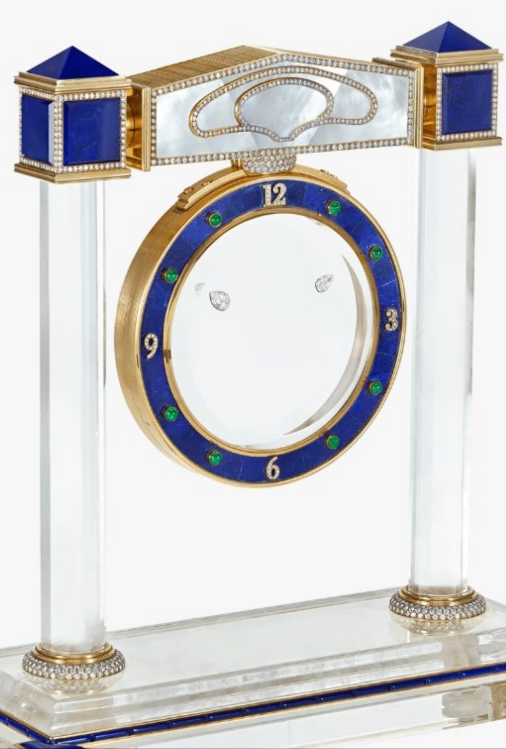 Diamond Mystery Clock Floating 2,150 grams of 18K yellow gold and it is adorned with an array of exceptional gemstones: two pear-shaped diamonds (3.02 and 1.79 carats), 49.96 carats of round-cut diamonds and 9.60 carats of cabochon emeralds.
