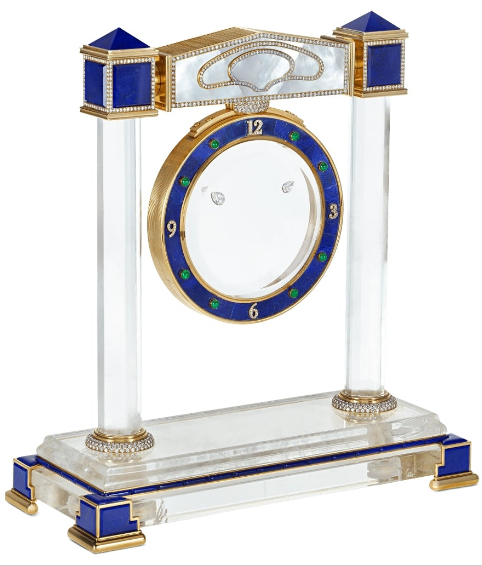 Diamond Mystery Clock Floating 2,150 grams of 18K yellow gold and it is adorned with an array of exceptional gemstones: two pear-shaped diamonds (3.02 and 1.79 carats), 49.96 carats of round-cut diamonds and 9.60 carats of cabochon emeralds.