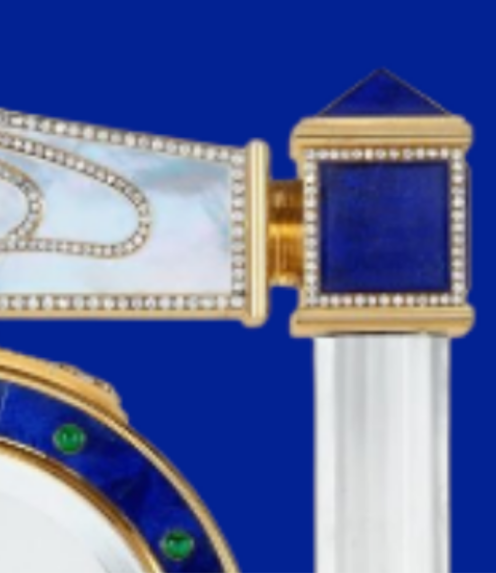 Diamond Mystery Clock Floating 2,150 grams of 18K yellow gold and it is adorned with an array of exceptional gemstones: two pear-shaped diamonds (3.02 and 1.79 carats), 49.96 carats of round-cut diamonds and 9.60 carats of cabochon emeralds.