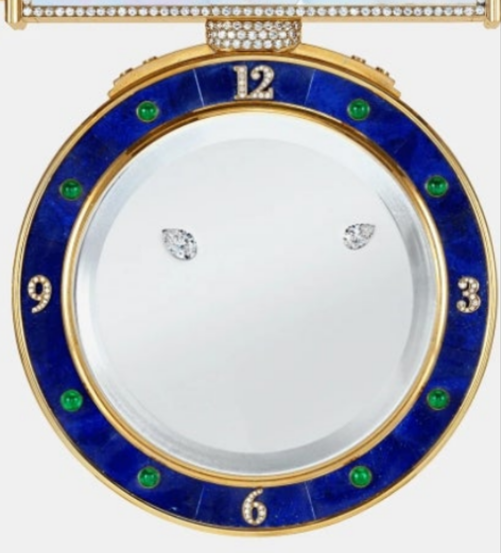 Diamond Mystery Clock Floating 2,150 grams of 18K yellow gold and it is adorned with an array of exceptional gemstones: two pear-shaped diamonds (3.02 and 1.79 carats), 49.96 carats of round-cut diamonds and 9.60 carats of cabochon emeralds.
