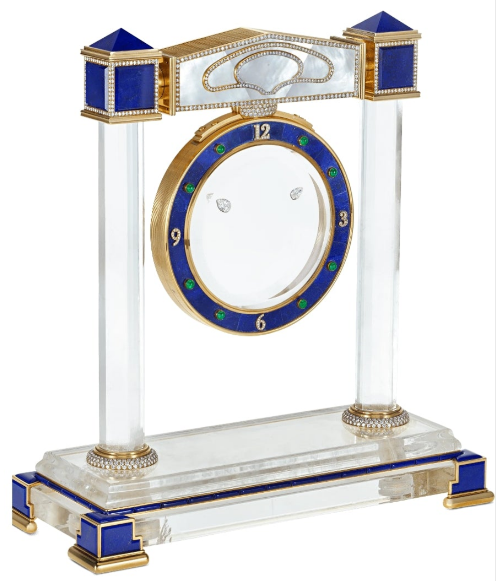 Diamond Mystery Clock Floating 2,150 grams of 18K yellow gold and it is adorned with an array of exceptional gemstones: two pear-shaped diamonds (3.02 and 1.79 carats), 49.96 carats of round-cut diamonds and 9.60 carats of cabochon emeralds.