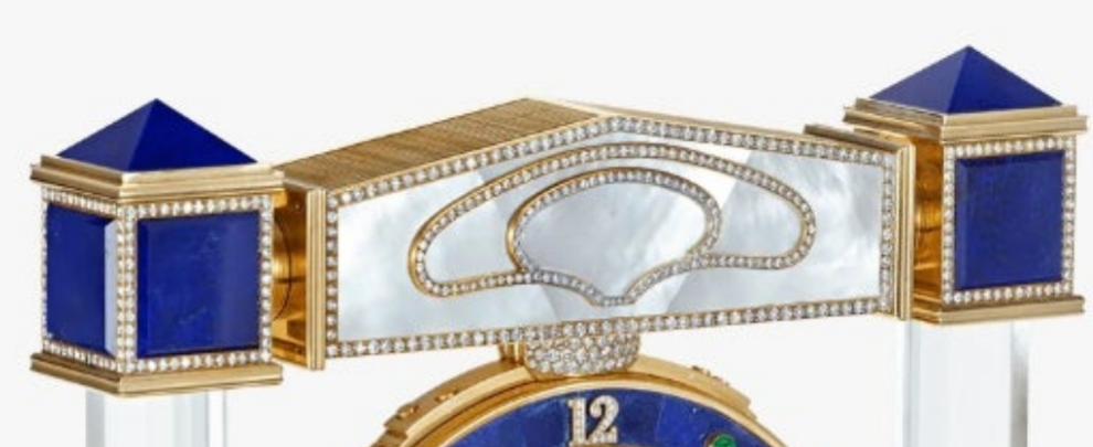 Diamond Mystery Clock Floating 2,150 grams of 18K yellow gold and it is adorned with an array of exceptional gemstones: two pear-shaped diamonds (3.02 and 1.79 carats), 49.96 carats of round-cut diamonds and 9.60 carats of cabochon emeralds.