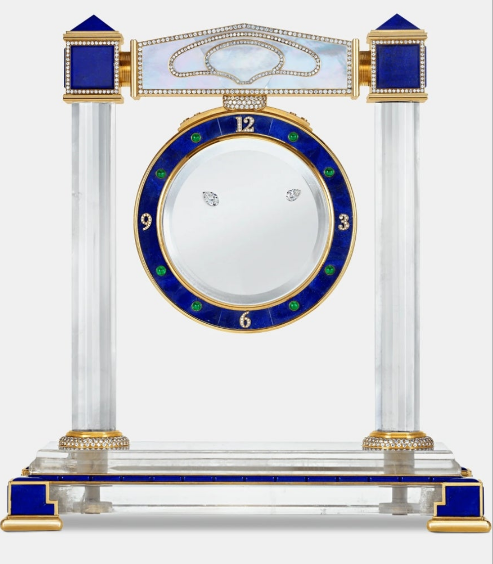 Diamond Mystery Clock Floating 2,150 grams of 18K yellow gold and it is adorned with an array of exceptional gemstones: two pear-shaped diamonds (3.02 and 1.79 carats), 49.96 carats of round-cut diamonds and 9.60 carats of cabochon emeralds.