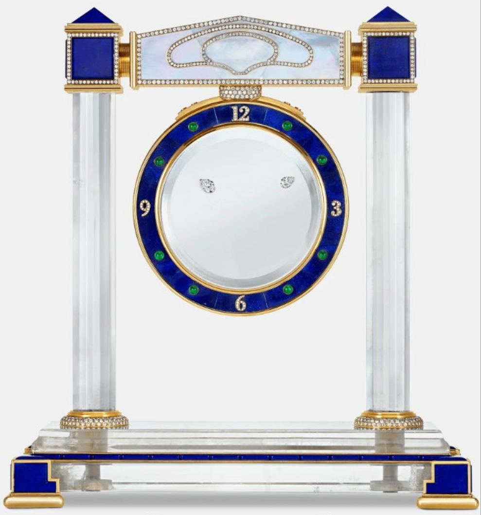 Diamond Mystery Clock Floating 2,150 grams of 18K yellow gold and it is adorned with an array of exceptional gemstones: two pear-shaped diamonds (3.02 and 1.79 carats), 49.96 carats of round-cut diamonds and 9.60 carats of cabochon emeralds.