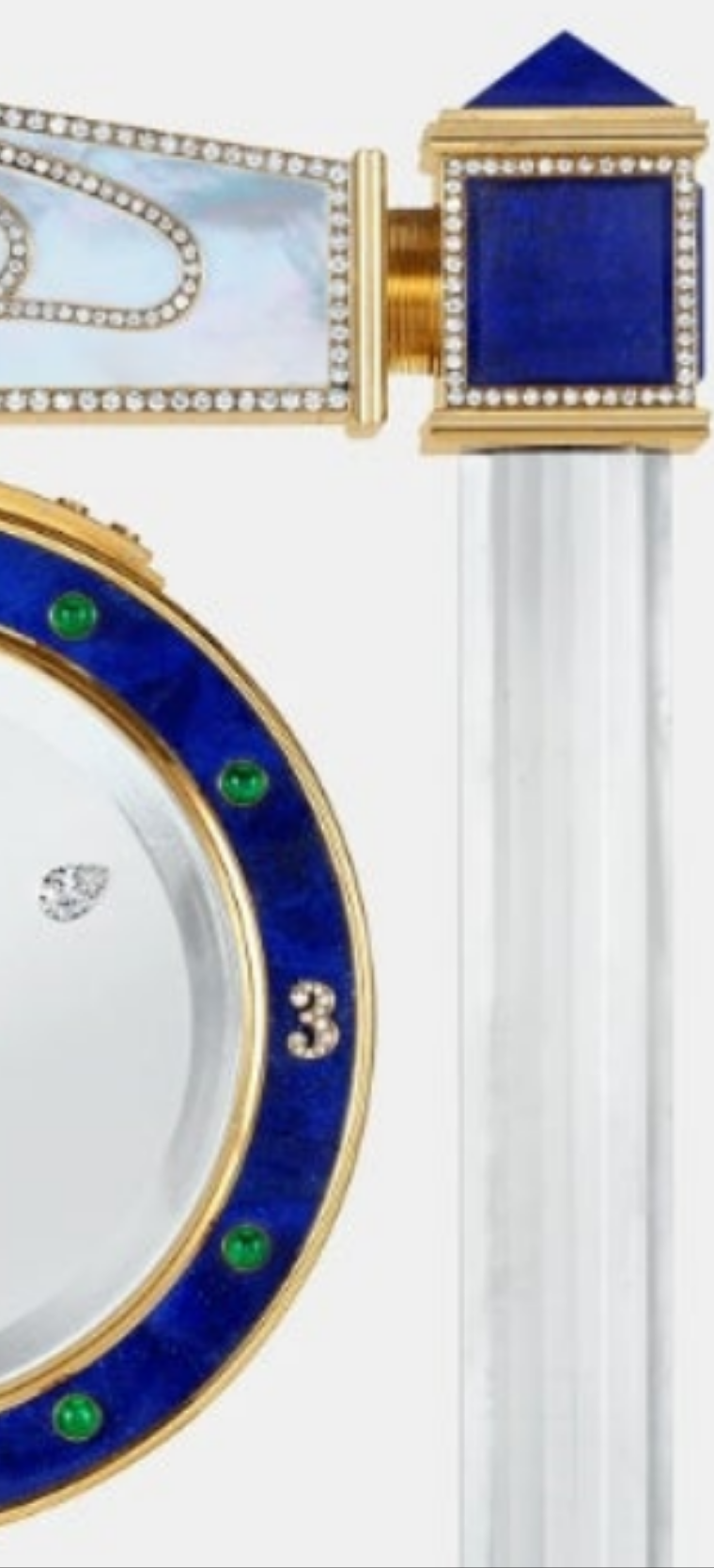 Diamond Mystery Clock Floating 2,150 grams of 18K yellow gold and it is adorned with an array of exceptional gemstones: two pear-shaped diamonds (3.02 and 1.79 carats), 49.96 carats of round-cut diamonds and 9.60 carats of cabochon emeralds.