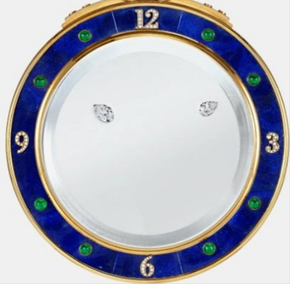 Diamond Mystery Clock Floating 2,150 grams of 18K yellow gold and it is adorned with an array of exceptional gemstones: two pear-shaped diamonds (3.02 and 1.79 carats), 49.96 carats of round-cut diamonds and 9.60 carats of cabochon emeralds.