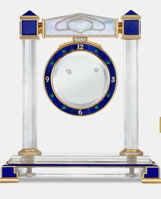 Diamond Mystery Clock Floating 2,150 grams of 18K yellow gold and it is adorned with an array of exceptional gemstones: two pear-shaped diamonds (3.02 and 1.79 carats), 49.96 carats of round-cut diamonds and 9.60 carats of cabochon emeralds.