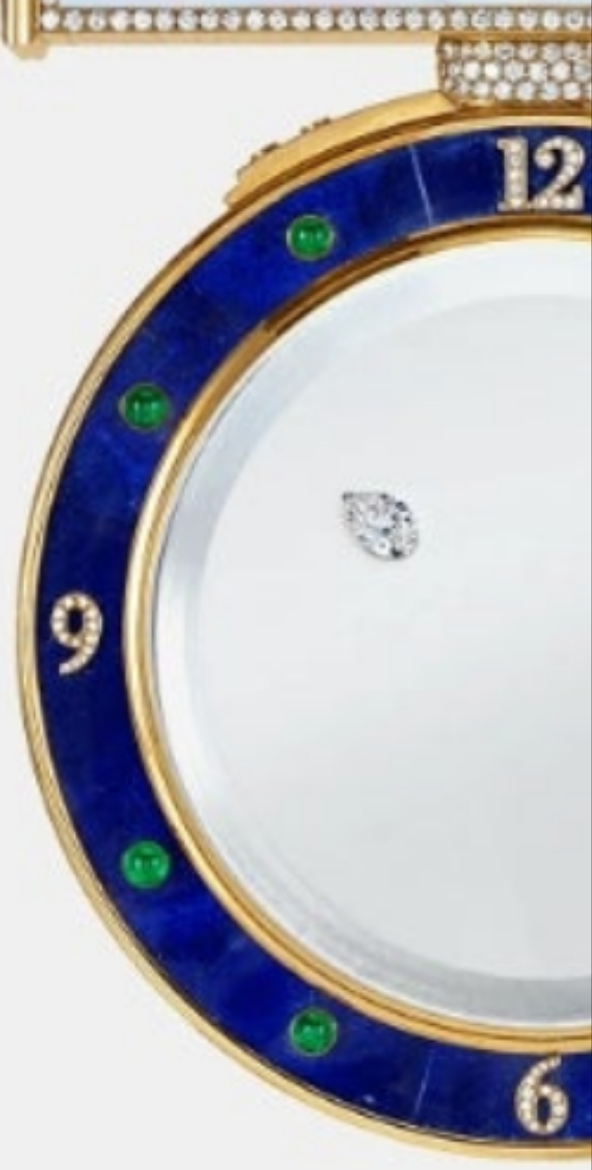 Diamond Mystery Clock Floating 2,150 grams of 18K yellow gold and it is adorned with an array of exceptional gemstones: two pear-shaped diamonds (3.02 and 1.79 carats), 49.96 carats of round-cut diamonds and 9.60 carats of cabochon emeralds.
