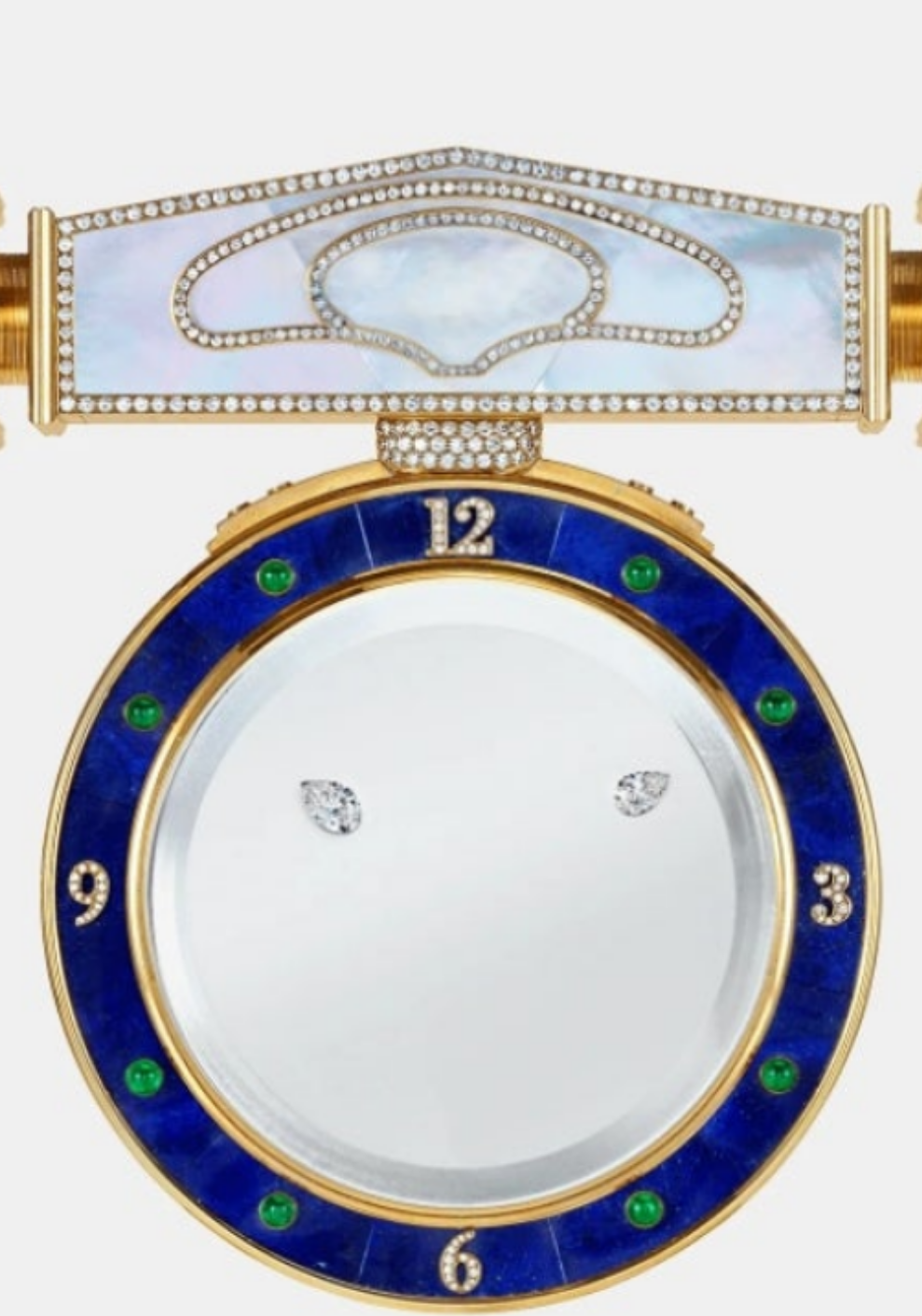 Diamond Mystery Clock Floating 2,150 grams of 18K yellow gold and it is adorned with an array of exceptional gemstones: two pear-shaped diamonds (3.02 and 1.79 carats), 49.96 carats of round-cut diamonds and 9.60 carats of cabochon emeralds.