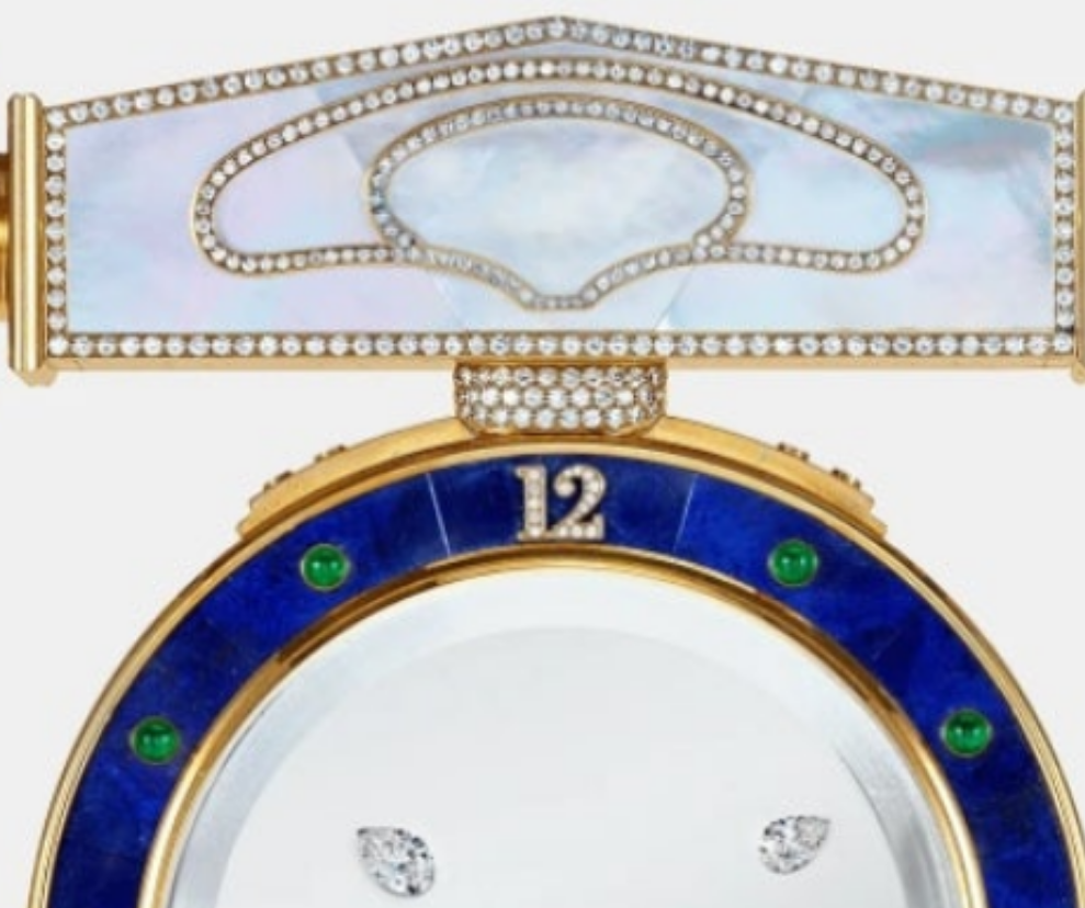 Diamond Mystery Clock Floating 2,150 grams of 18K yellow gold and it is adorned with an array of exceptional gemstones: two pear-shaped diamonds (3.02 and 1.79 carats), 49.96 carats of round-cut diamonds and 9.60 carats of cabochon emeralds.